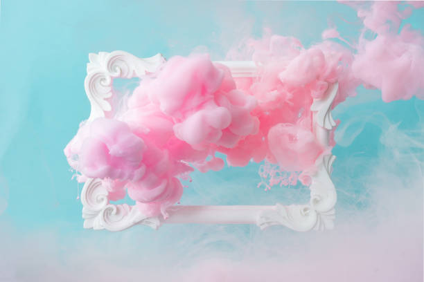 istock White vintage frame on pastel blue background with abstract pink cloud shapes. 1089378390