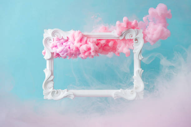 istock White vintage frame on pastel blue background with abstract pink cloud shapes. 1089379436