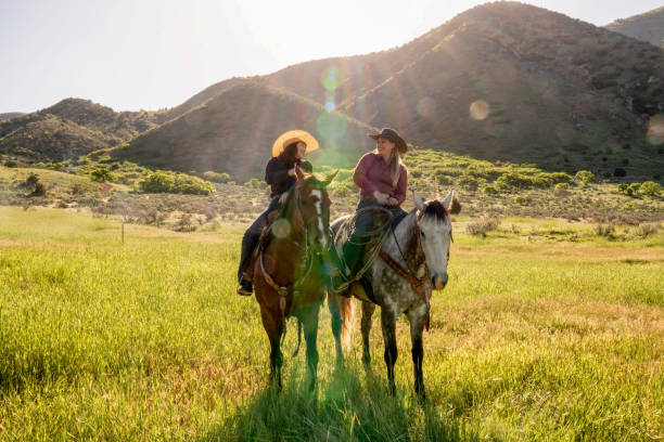 istock Two Young Women Riding Their Horses On The Open Range 1089380886
