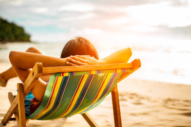 istock Woman relaxing on beach, looking at sea. Copy space. 1089381700