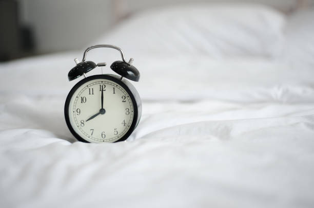 istock Alarm clock in bed in the morning. 1089382660