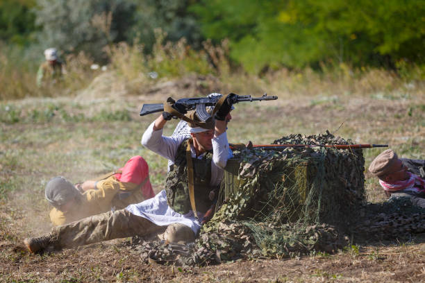 Mujahideen shoot from behind cover SAMBEK, ROSTOV REGION, RUSSIA, AUGUST 19, 2018: Historical festival Sambek Heights. Mujahideen shoot from behind cover afghanistan army stock pictures, royalty-free photos & images