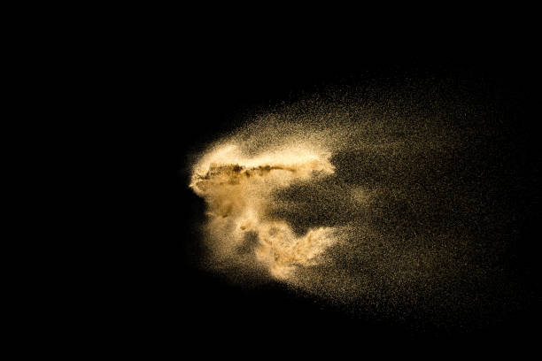 istock Abstract sand cloud. Golden colored sand splash against dark background. 1089387600