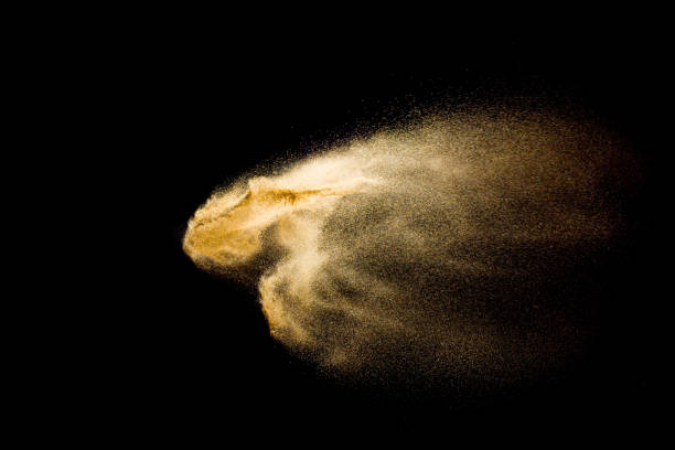 istock Abstract sand cloud. Golden colored sand splash against dark background. 1089387620