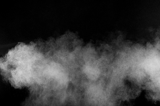 Abstract white powder explosion against black background.Abstract white dust exhale.