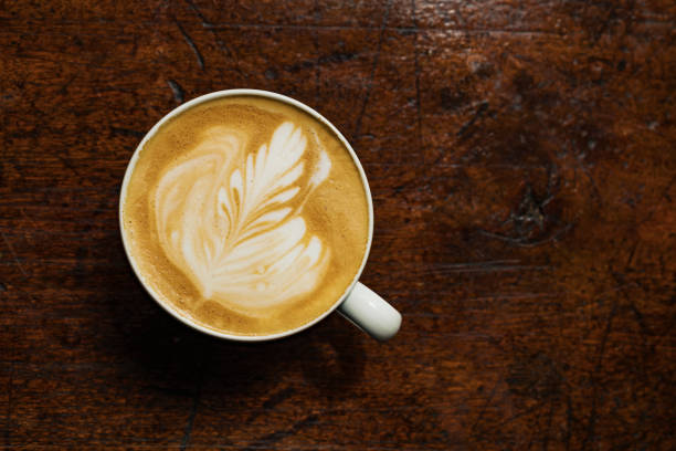 istock Overhead Flat White Coffee against an aged wood background. 1089390074
