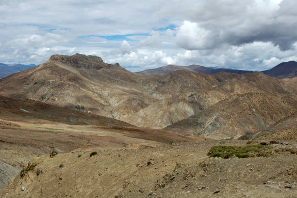 istock Tibetan landscape with brown mountains and clouds 1089390390