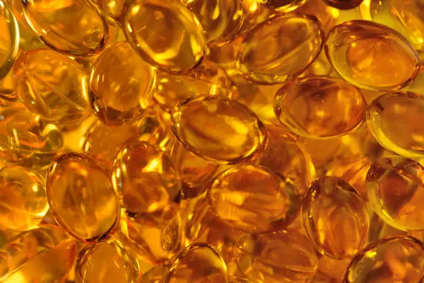 background from the transparent capsules filled an omega or fish oil