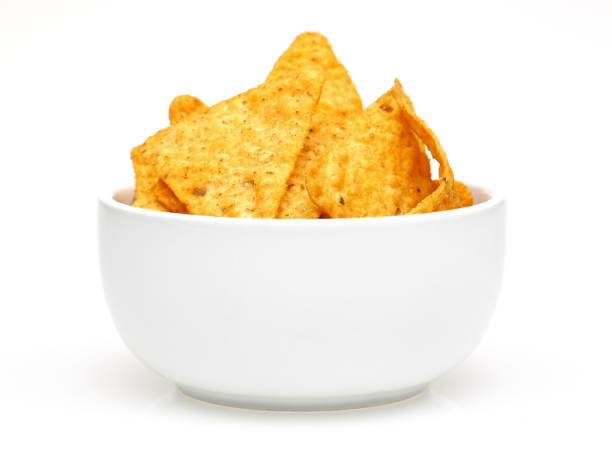 Corn chips in bowl isolated on white background Corn chips in white bowl isolated on white background tortilla chip photos stock pictures, royalty-free photos & images