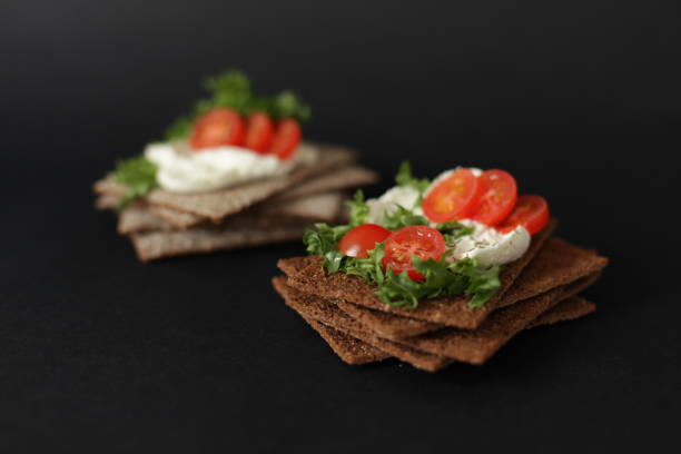 rice cake with cream cheese, tomatoes and herbs isolatetd on a white background