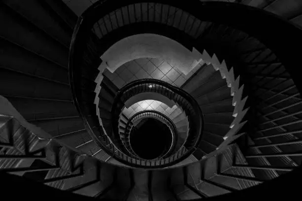 Photo of Spiral staircase in an old building,lack and white, monochromatic