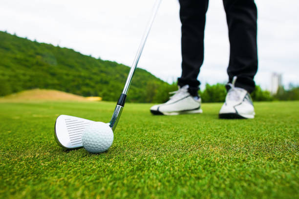 istock Golf course green and golf ball close in the grass field. 1089399002