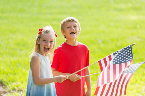 istock Children, siblings, holding american flags 1089399346