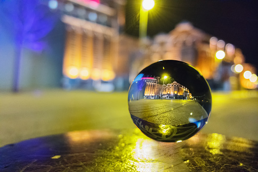 Photo of the Tagus River riverbank in Lisbon at nigjt trough a crystal ball.