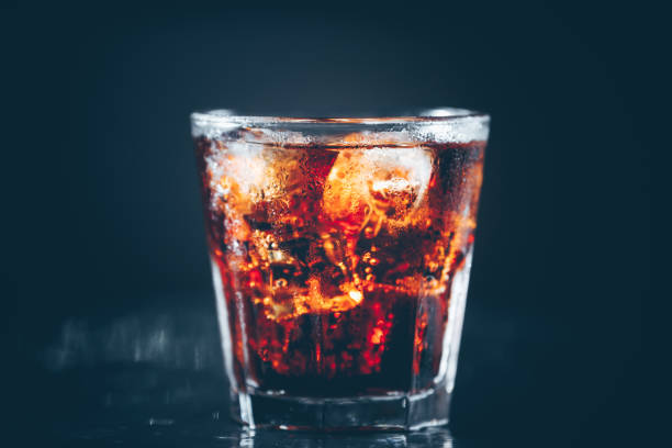 istock Cuba libre cocktail at the bar stand. Dark background 1089401732