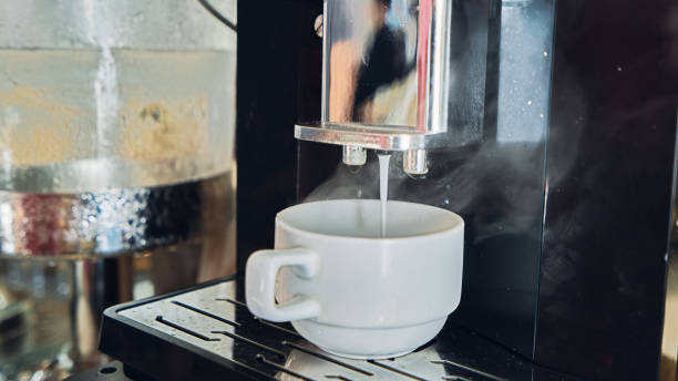 istock Coffee pouring from the machine to white cup 1089402796