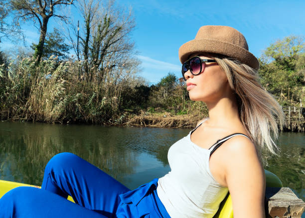 Woman paddling pedal boat on river