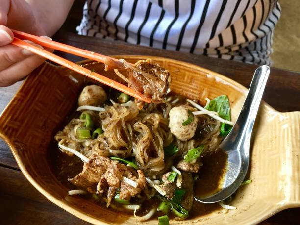 Spices noodle in a bowl with chopstick
