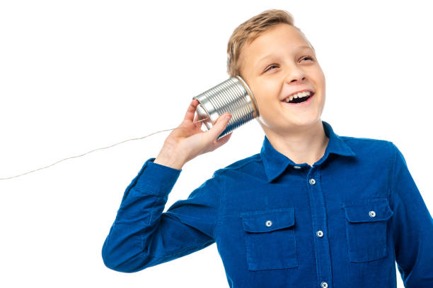 istock smiling boy holding tin with rope near ear isolated on white 1089408206