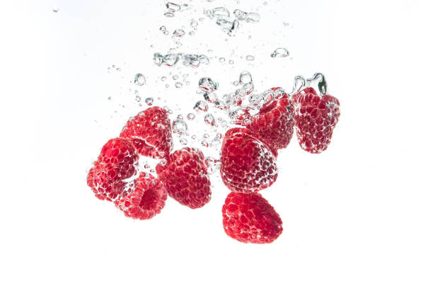 istock Raspberries splashing into crystal clear water with air bubbles 1089410768