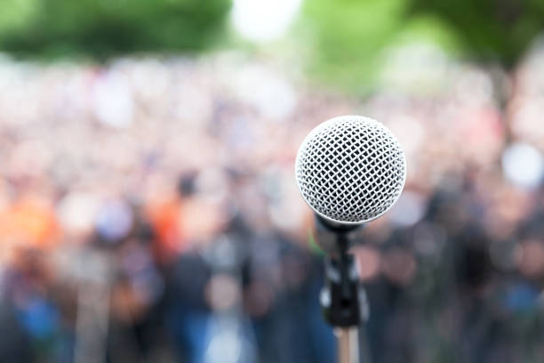 istock Microphone in focus against blurred protest or public demonstration 1089416800