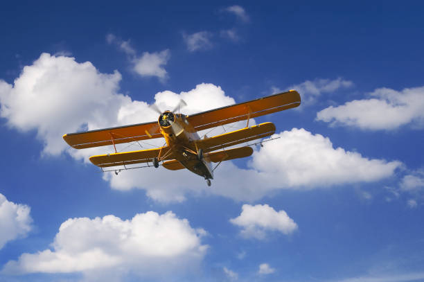 istock Yellow propeller airplane with double wings flying 1089417692