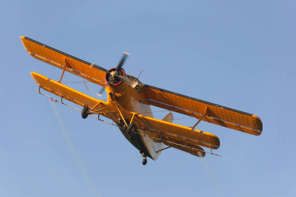 istock Yellow propeller airplane with double wings flying 1089417700