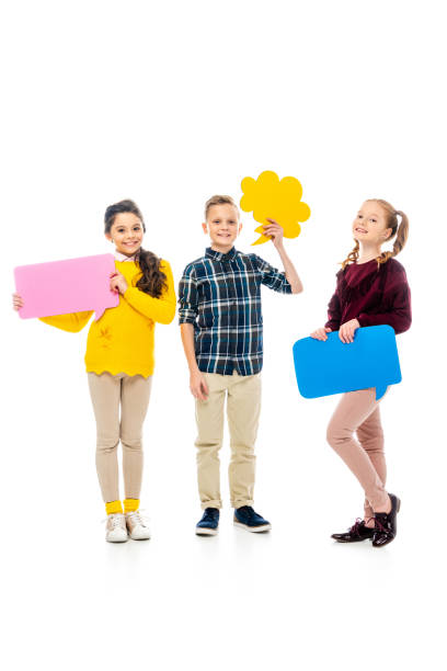 istock happy kids smiling, holding multicolored speech bubbles and looking at camera isolated on white 1089417754