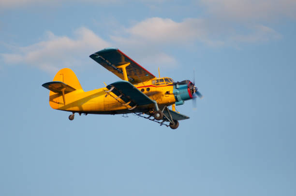 istock Yellow propeller airplane with double wings flying 1089417854