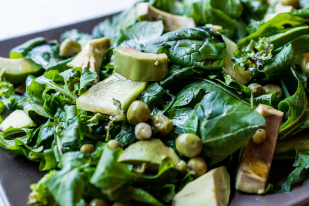 istock Avocado Salad with Green Peas and Rocket Leaves in Rectangular Plate / Arugula or Rucola Leaves. 1089420730