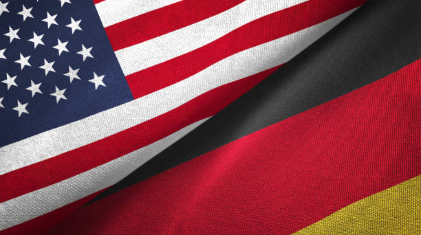 德國和美國兩旗一起實現紡織布織物的質地 - 德國國旗 個照片及圖片檔