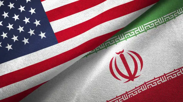 Photo of Iran and United States two flags together realations textile cloth fabric texture