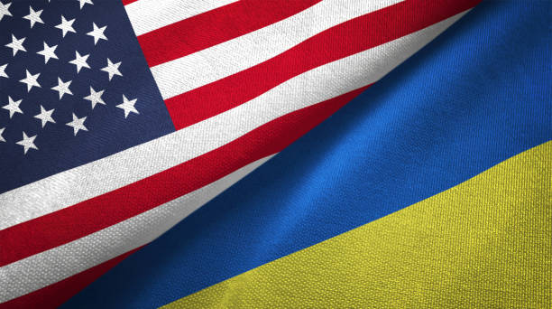 烏克蘭和美國的兩面旗幟一起實現紡織布織物的質地 - 烏克蘭 圖片 個照片及圖片檔
