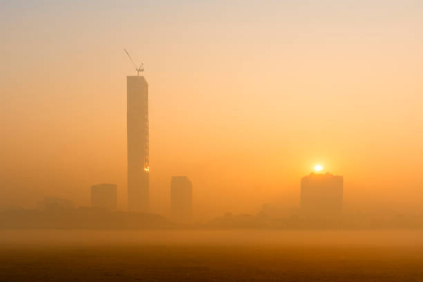 Beautiful image of sunrise at Kolkata maidan in a foggy winter morning. Sunrises at the horizon above Kolkata (formerly Calcutta) city skyscappers.