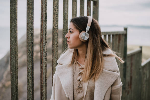istock Young woman wearing headphones 1089437530