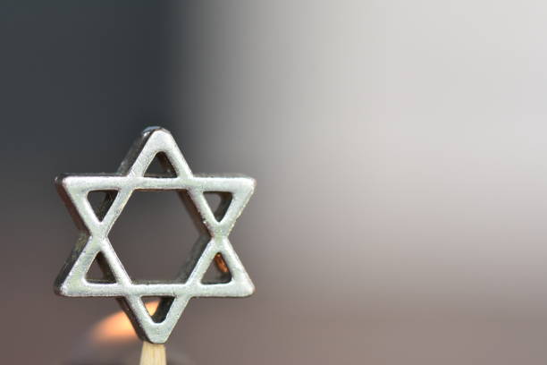 Star of David on a candle background Star of David on a candle background judaism photos stock pictures, royalty-free photos & images