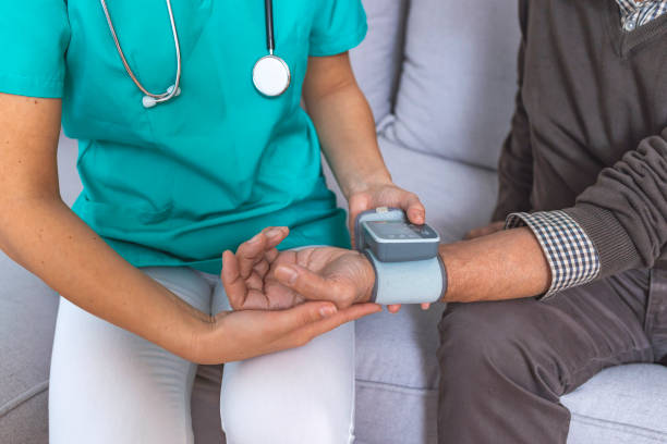 istock Female nurse consulting with elderly patient while testing blood pressure. 1089453336