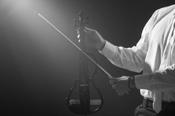 istock The musician holds a electronic violin in his hands 1089454830