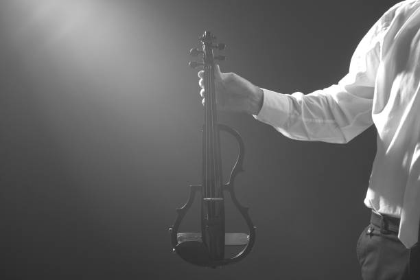 istock The musician holds a electronic violin in his hands 1089454832