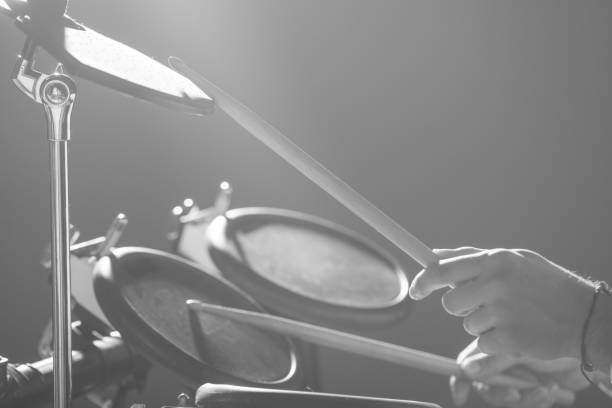 istock Drummer. The guy holds drum sticks in his hand against the background electronic drum. Young man with drum sticks. 1089454882