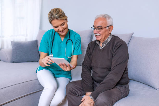 istock Young nurse spending time with happy elder patient in nursing home 1089456094