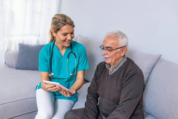 istock Young nurse spending time with happy elder patient in nursing home 1089457334