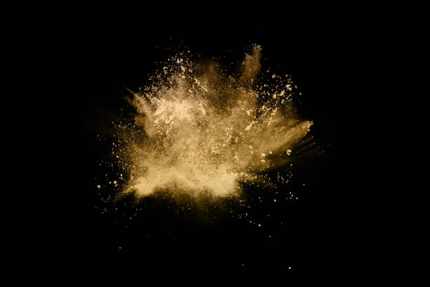 istock Golden powder explosion on black background. Freeze motion. 1089457474