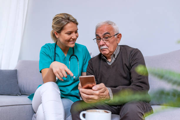 istock Young nurse spending time with happy elder patient in nursing home 1089458322
