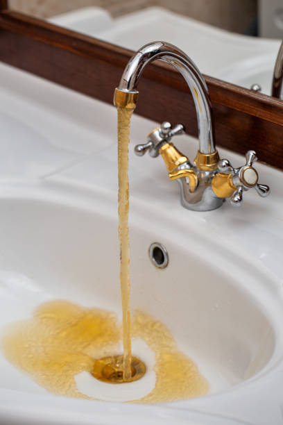 istock Dirty rusty water flows from the faucet 1089469760