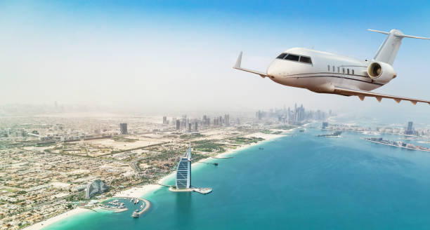 istock Private jet plane flying above Dubai city 1089470718