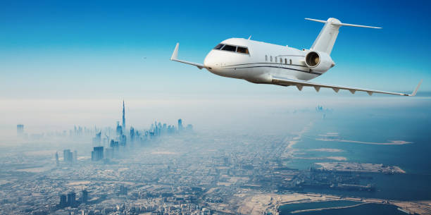 istock Private jet plane flying above Dubai city 1089470752