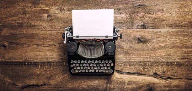 istock Vintage typewriter paper wooden background toned 1089472990