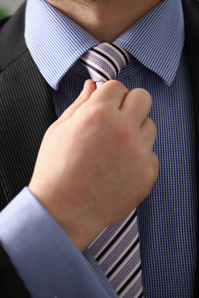 istock Male arm in brown suit set tie closeup 1089473472