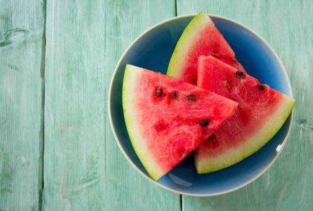 istock freshly cut water melon on wooden table 1089475512